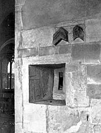 PLATE VIII. Squint between South Chapel and Chancel, constructed partly of a Mason's Tombstone. Note the zig-zag Moulding of Norman Chancel.