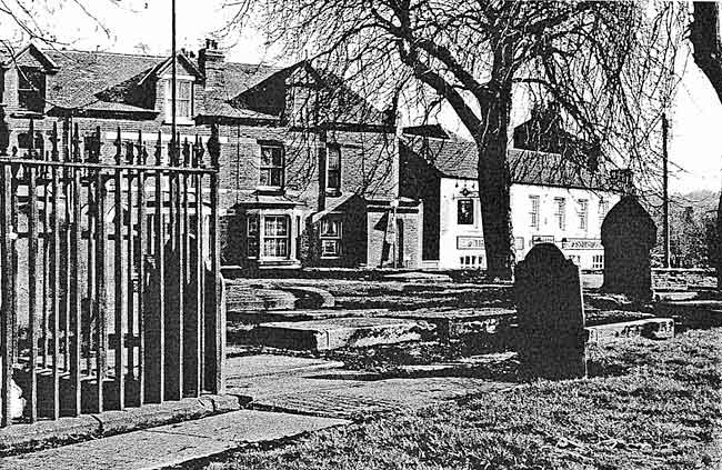 A view of the churchyard in the winter of 1991, showing the horse-chestnut which had to be felled in 2004. The railing in the foreground is part of the memorial to Thomas Martin.
