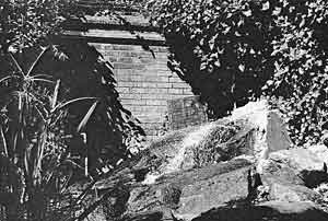 THE WATER CASCADE in 2004. The headstone has been brought in from the Rest Garden, next door.